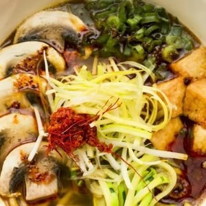 Spicy Vegan Curry Ramen with tofu, mushrooms, and fresh vegetables